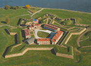 Aerial close-up photo of Fort McHenry Star Fort with flag flying and showing shoreline of Patapsco River Baltimore MD
