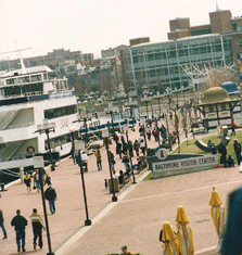 Baltimore's Inner Harbor Waterfront Promenade with view of the Science Center and a tour boat