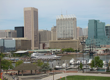 Baltimore's Inner Harbor skyline wide-shot taken from Federal Hill showing Rash Field, Inner Harbor Marina yachts, USS Constellation, tour boats and both Harborplace Pavilions