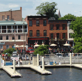 Lovely Fell's Point Waterfront View taken from the Water featuring Woody's Rum Bar & Island Grill, Slainte Irish Pub & Restaurant and Kooper's Tavern on Historic Thames Street Baltimore MD 