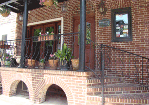 la Scala Ristorante Italiano image of attractive inviting brick front entrance with potted plants and hanging flowers on Eastern Avenue in Little Italy Baltimore MD