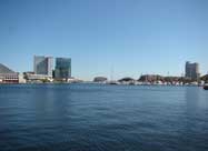 Gorgeous view of Baltimore's magnificent inner harbor looking out from the Harborplace Waterfront Promenade, with views of the National Aquarium, Baltimore Marriott Waterfront Hotel, the Legg Mason building, yachts at the Inner Harbor Marina, the Harborview Tower Condominiums, and historic Fell's Point in the distance