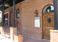 la Scala Ristorante Italiano image of attractive inviting brick front entrance with potted plants and hanging flowers on Eastern Avenue in Little Italy Baltimore MD